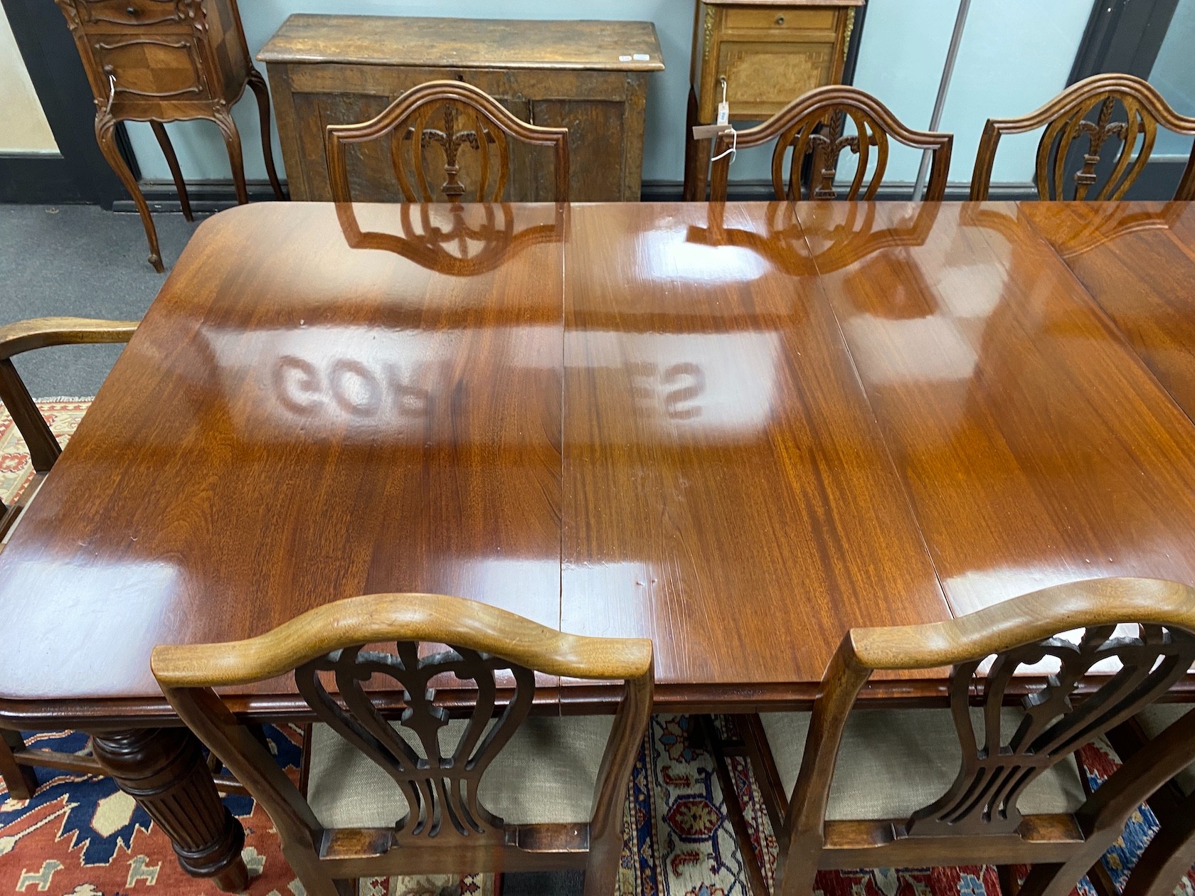 A late Victorian mahogany extending dining table, length 209cm extended with two spare leaves and winder, depth 106cm, height 76cm together with a set of eight Hepplewhite style dining chairs, two with arms